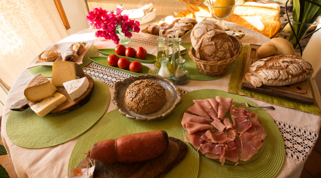  Charcuterie, cheese and bread served on the breakfast table